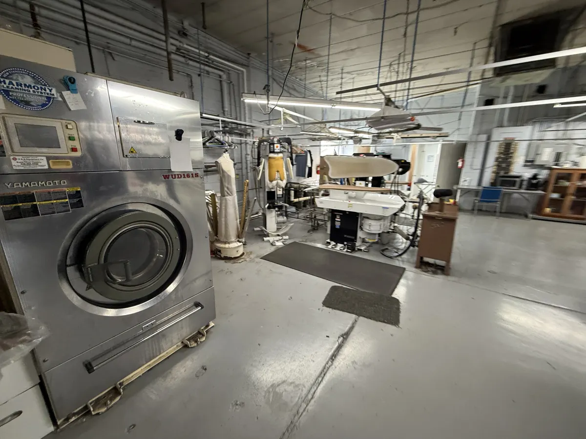 Commercial washer-extractor and garment pressing equipment used for textile cleaning
